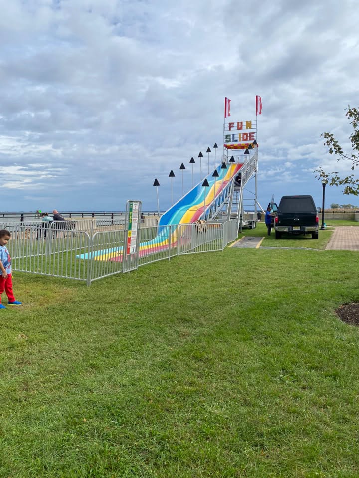 A large inflatable fun slide set up in a grassy field