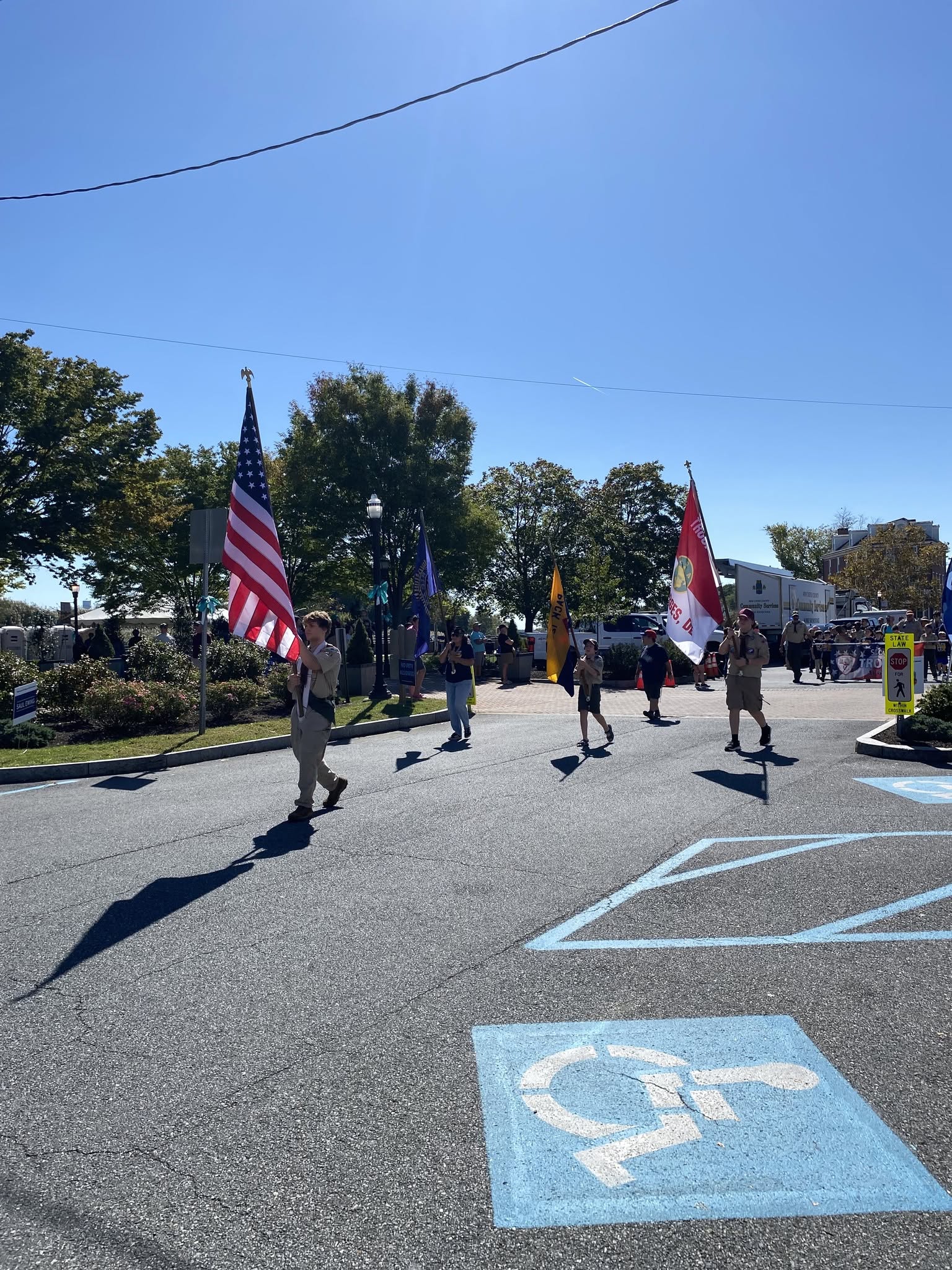 A color guard carrying flags down the parade route