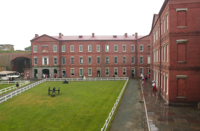 Fort Delaware’s grassy courtyard enclosed by historic red-brick buildings