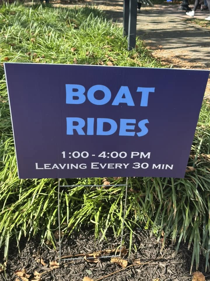 A yard sign advertising boat rides from one to four in the afternoon