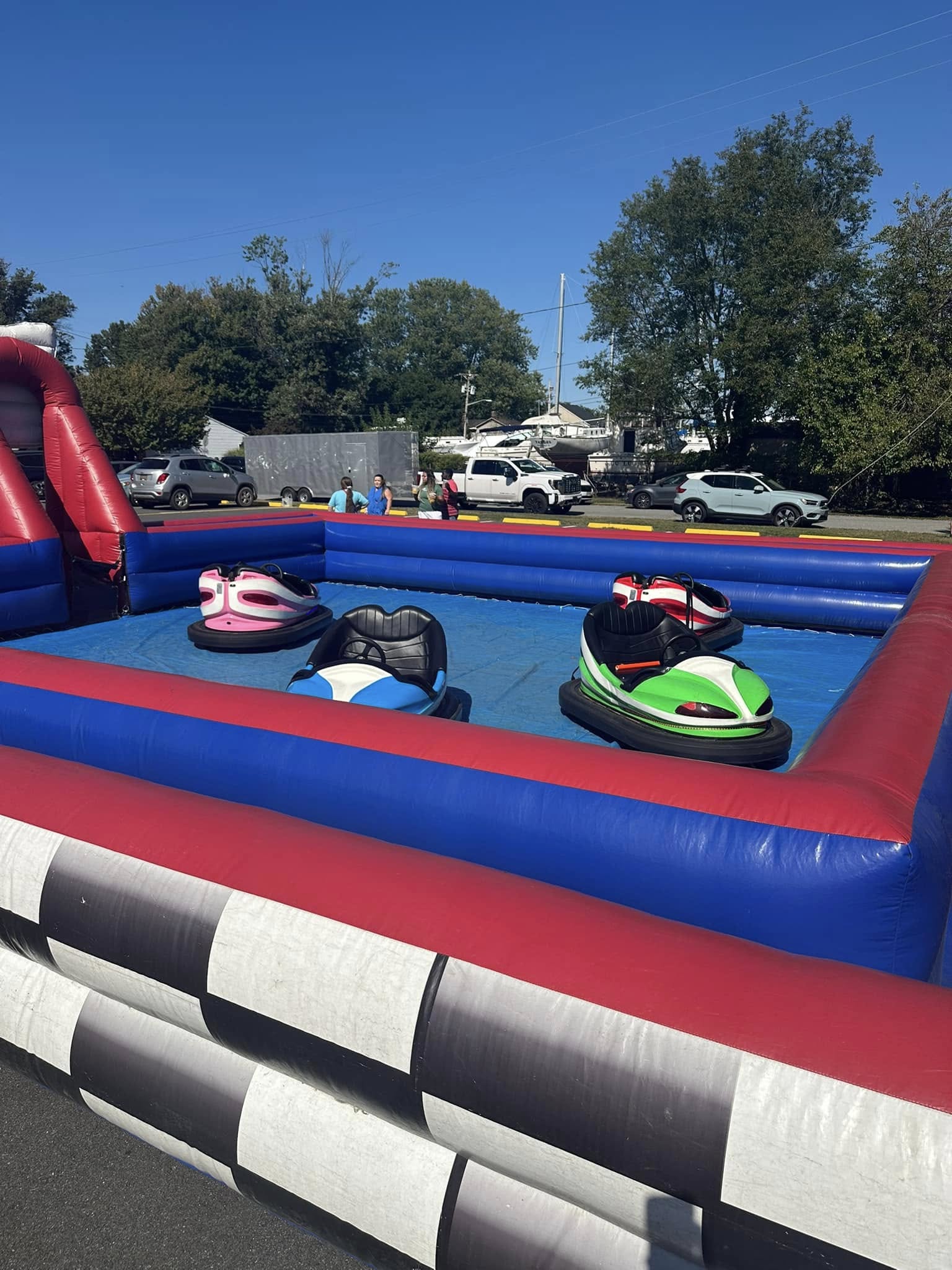 Children riding inflatable bumper cars on the festival field