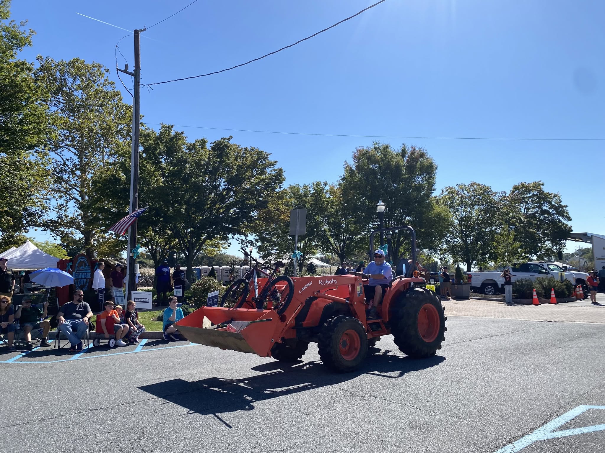An orange tractor rolling down the parade route