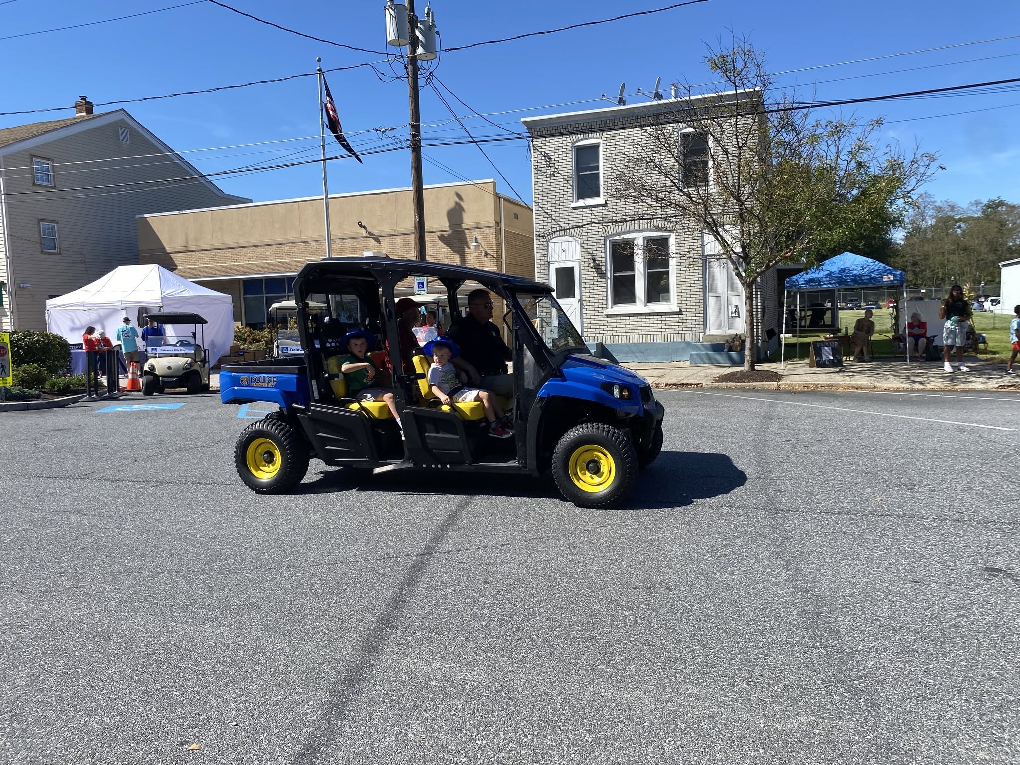 A utility cart driving along the parade route