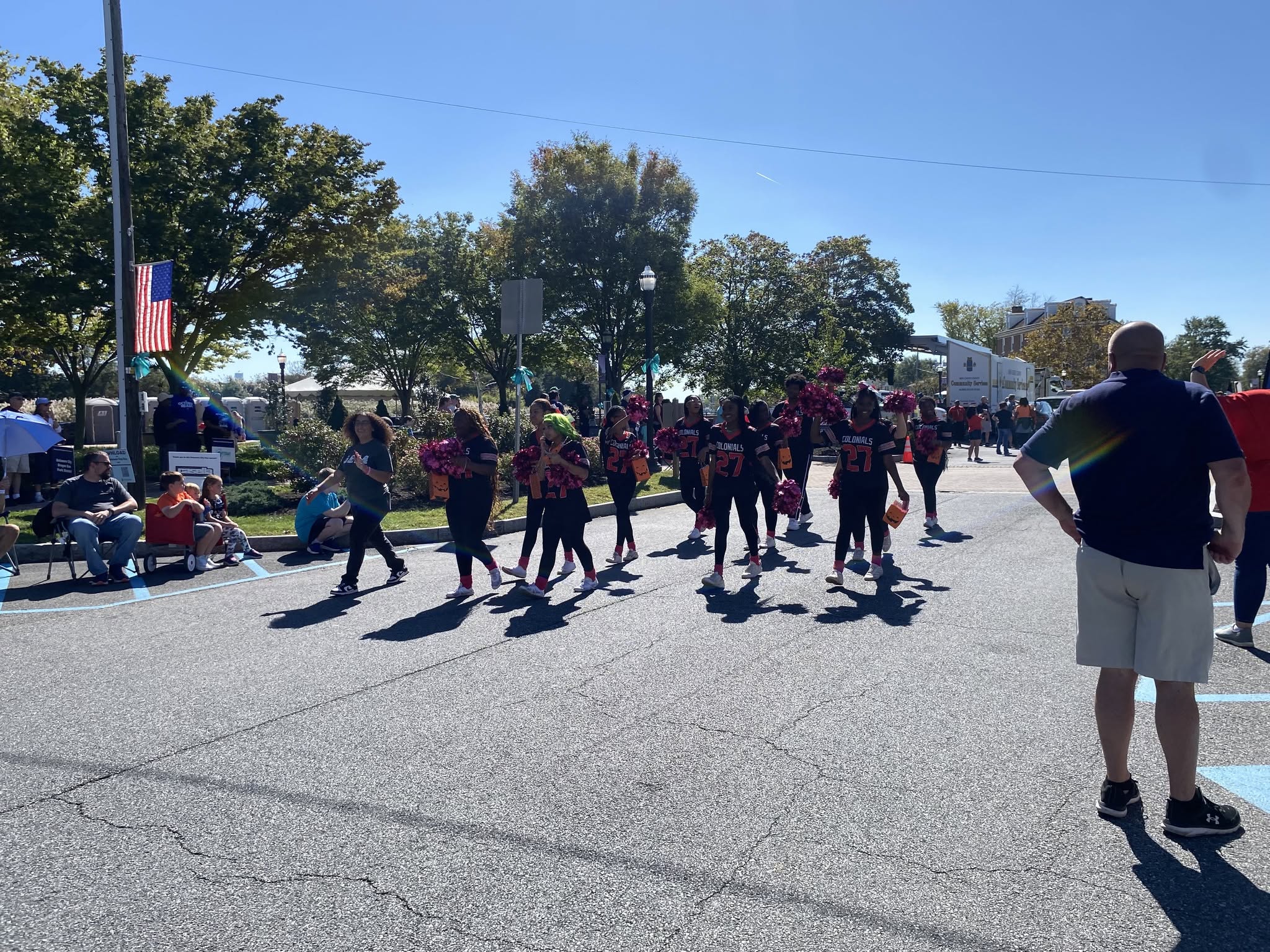 Spectators gathered as a marching youth group passes by
