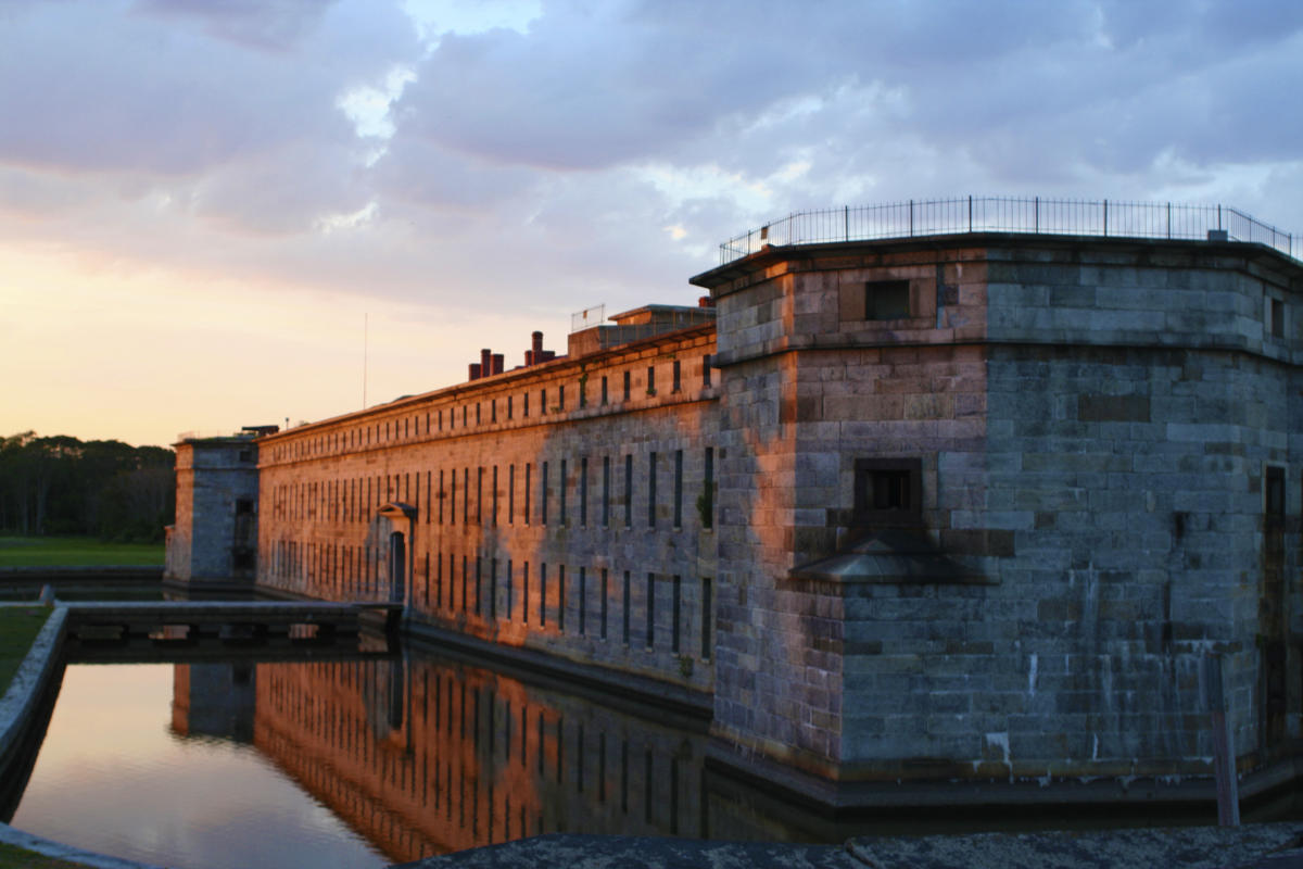 Evening light on Fort Delaware’s stone walls reflected in the moat