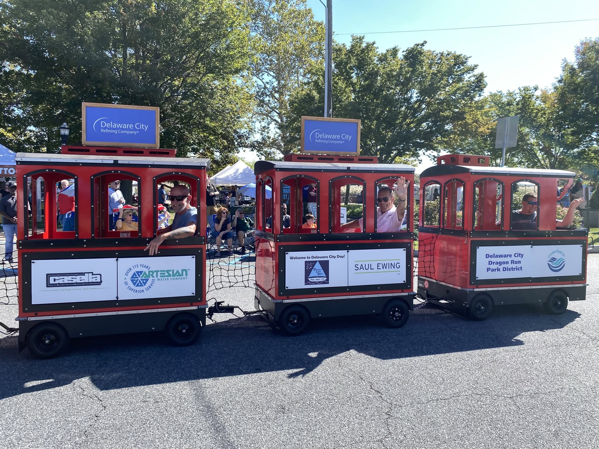Passenger cars of the trackless festival train parked on the field