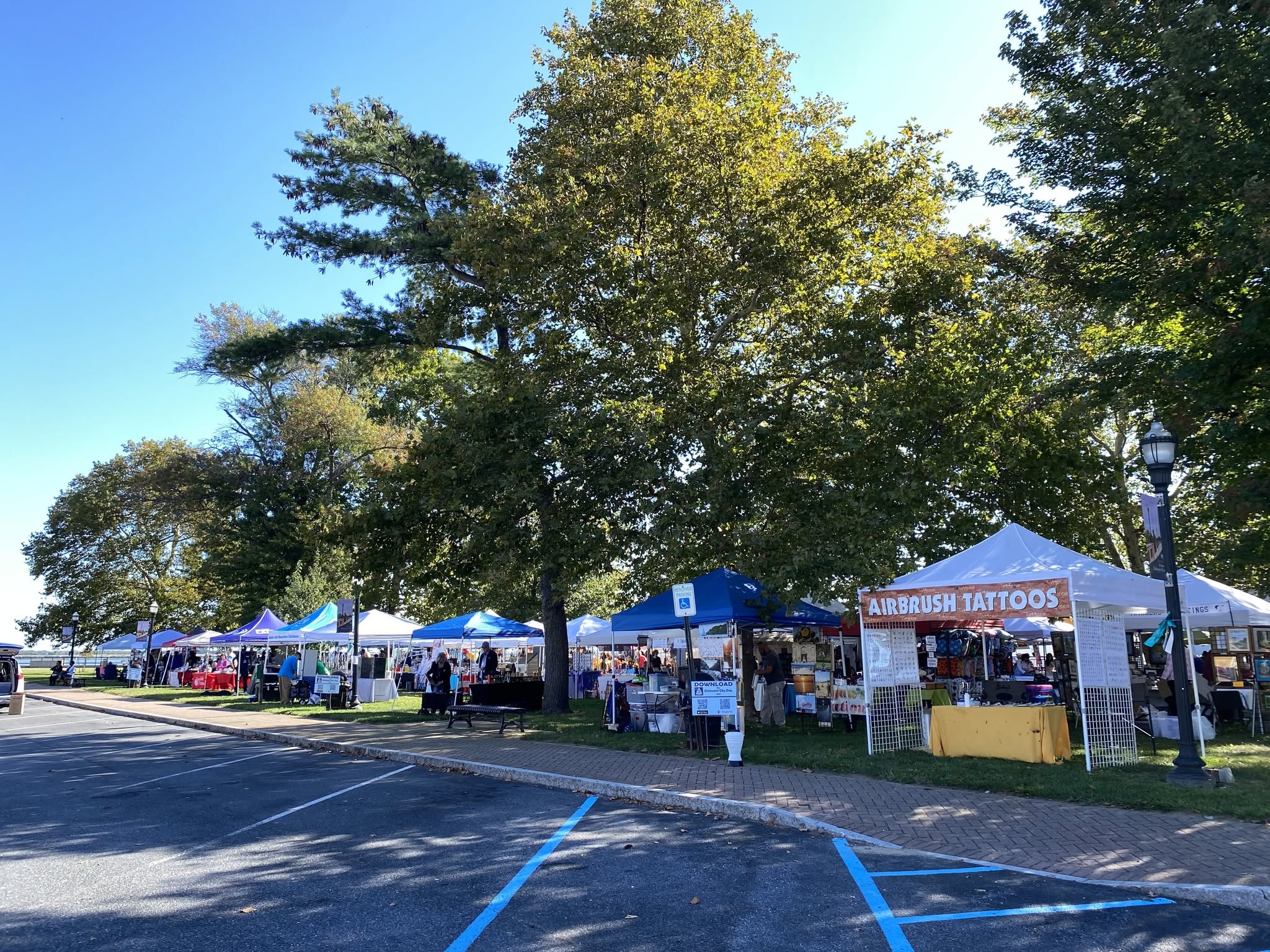 Vendor and community organization tents lined up across the field
