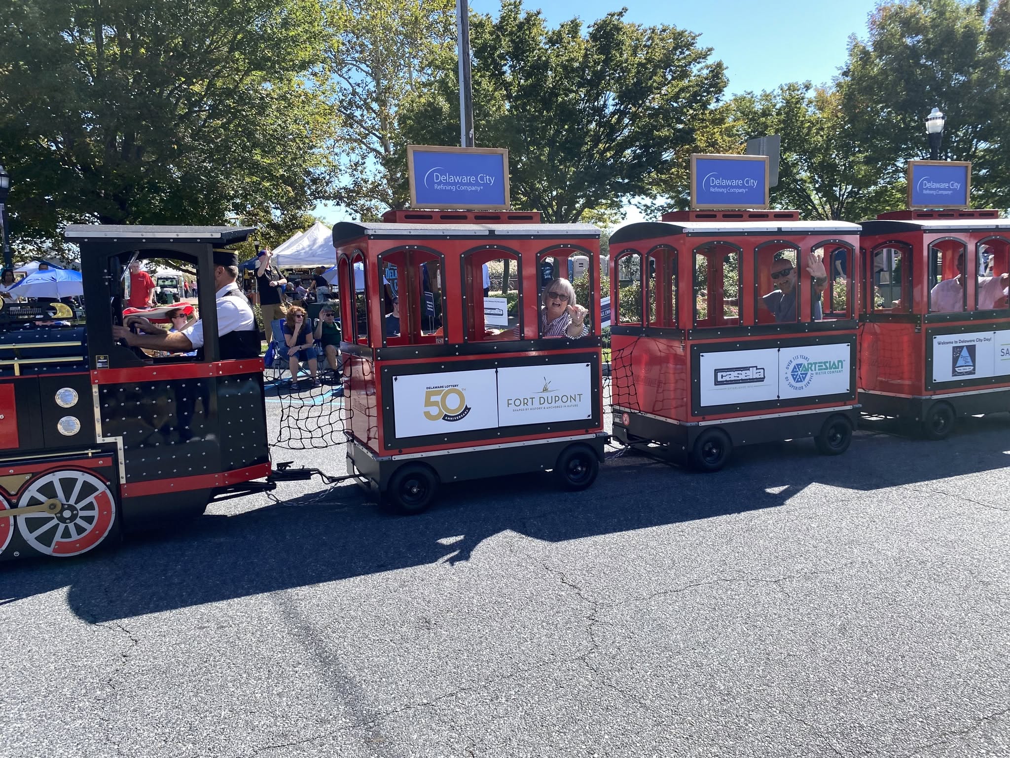 The festival train’s locomotive and passenger cars on the grass