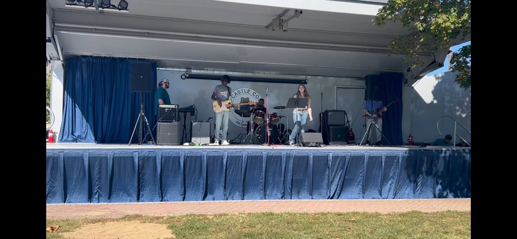 A band performing on the covered outdoor stage at Battery Park