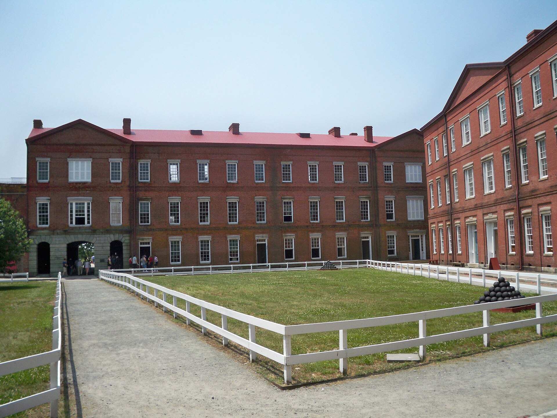 Historic brick buildings and green courtyard inside Fort Delaware